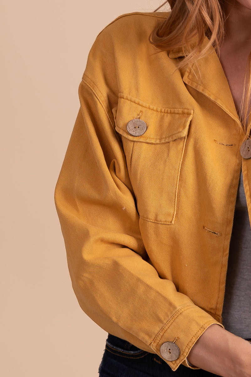 women's yellow cropped jacket with wooden button details