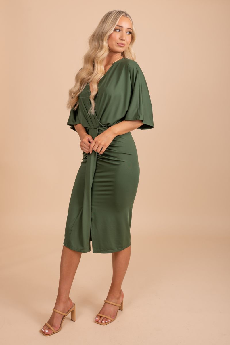 Chic and elegant v-neck faux wrap dress worn by a stunning model against a neutral tan backdrop
