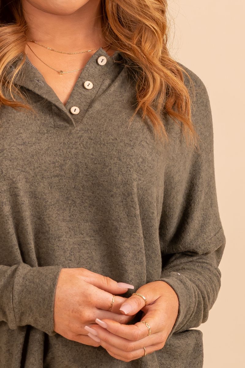 Womans long sleeve collared partly buttoned top