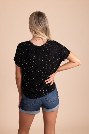 short sleeve black top with white patterns