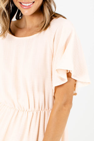 Women's boutique dress in off white with textured material
