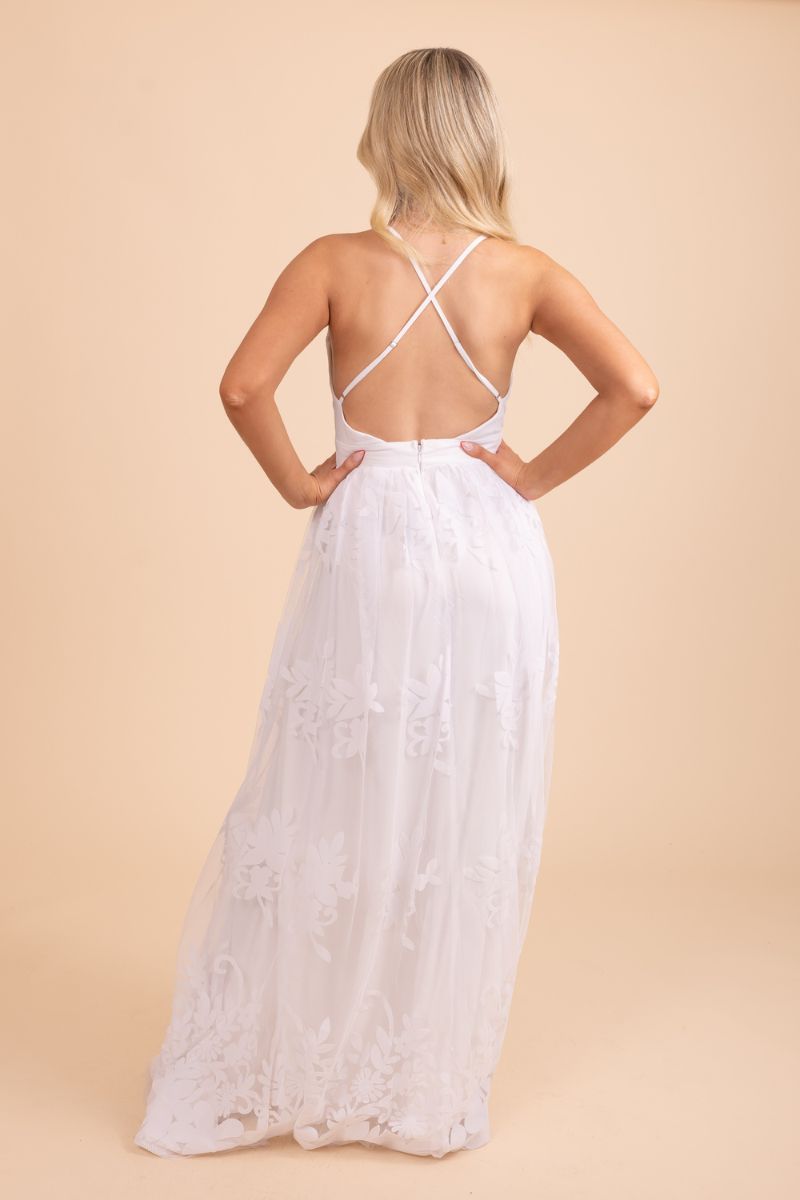 Back of white floor length maxi dress with lace and deep v-neck