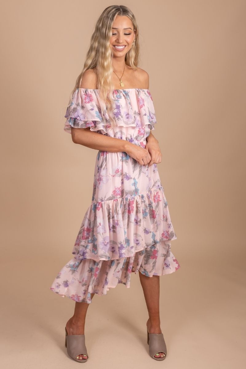 Pink women's dress with floral print and tiered skirt