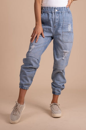 distressed women's jogger pants with cargo pockets in light denim