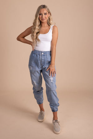 distressed women's jogger pants with cargo pockets in light denim