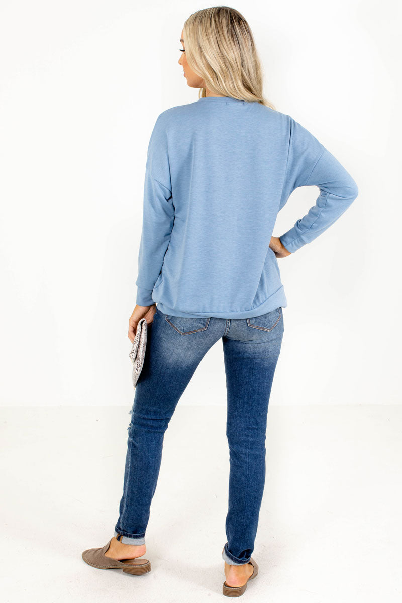 blue women's long sleeve top with front pocket