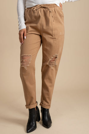 light camel brown joggers with distressed knees and pockets