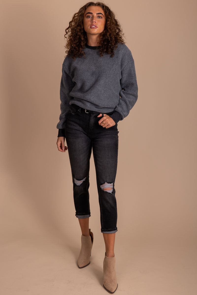 Women's outfit with long sleeve pullover top in charcoal gray.
