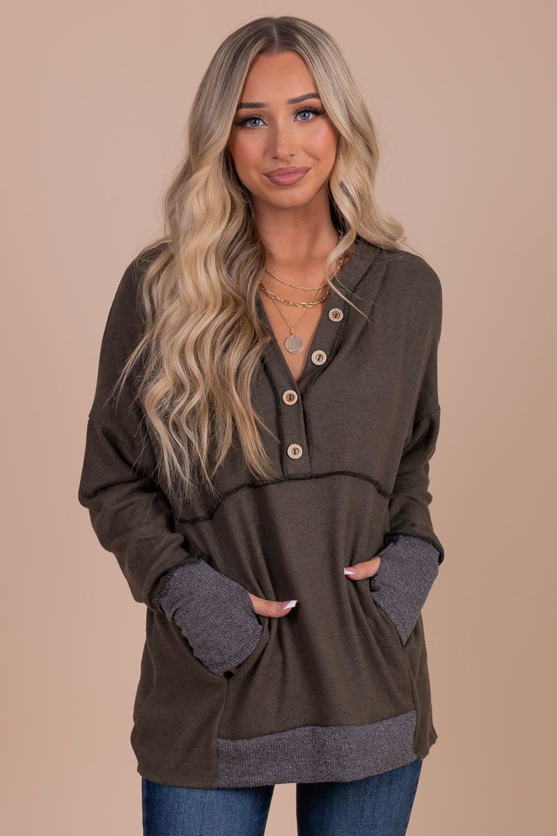 women's olive green hooded sweater with from pocket and button details