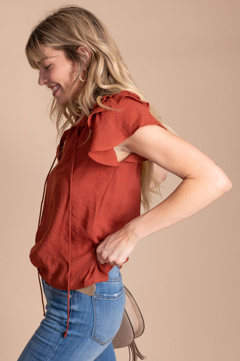 short sleeve ruffled blouse in brick red