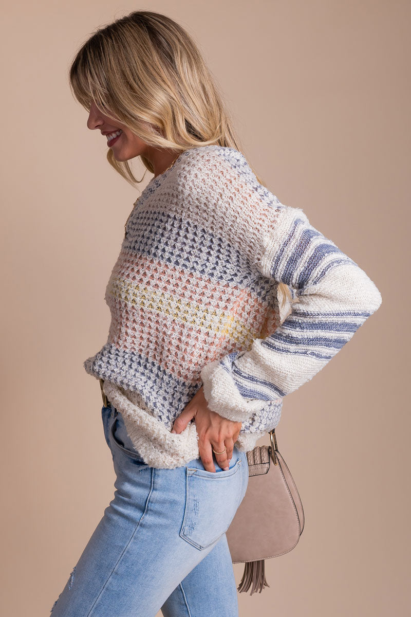 gray, white, pink, and yellow striped knit sweater
